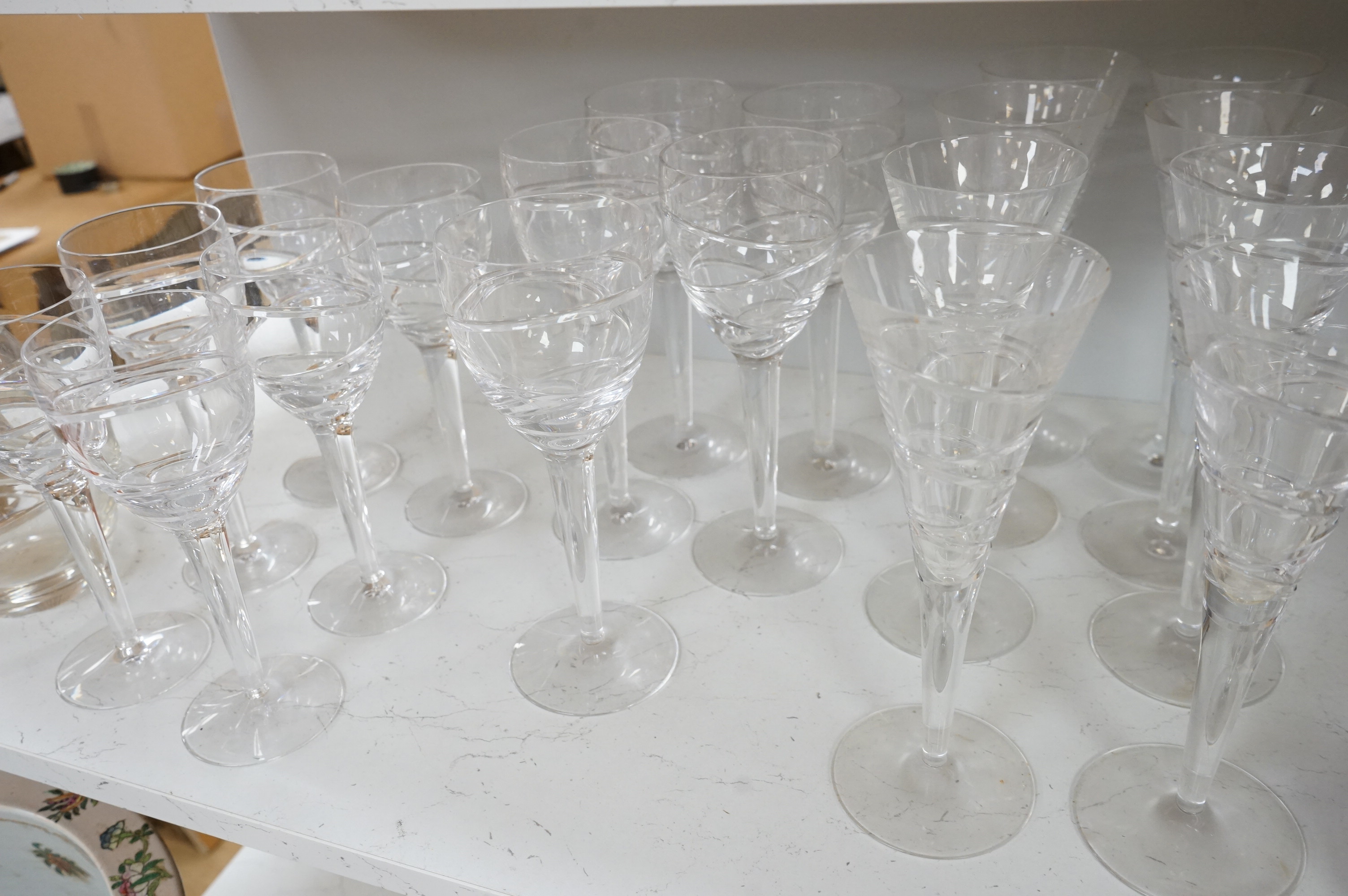 Various part suites of Jasper Conran hand cut Stuart Crystal ‘Aura’ glasses. Including eight Champagne, five large wine and six smaller wine glasses and a carafe, largest 27cm high